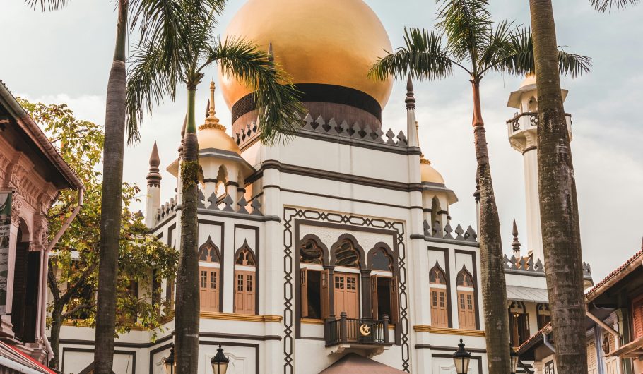 Beautiful golden dome of Masjid Sultan (Sultan Mosque) in Singapore with palm trees and tourists