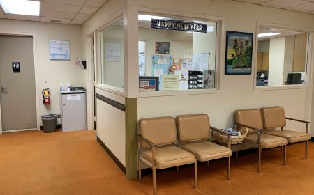 Interior of a 24 hour clinic waiting room in Singapore showing clean reception area with seating and patient information notices